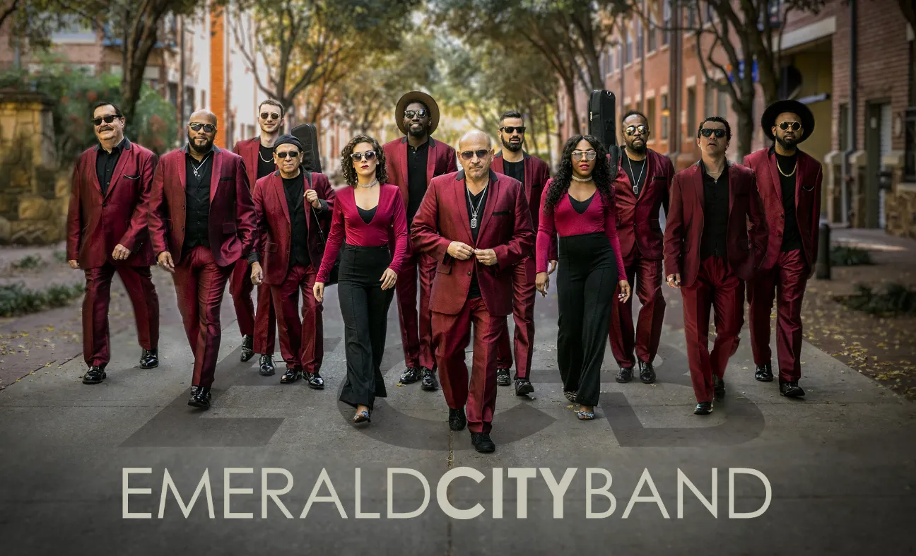 members of Emerald City band in red suits walking down a street