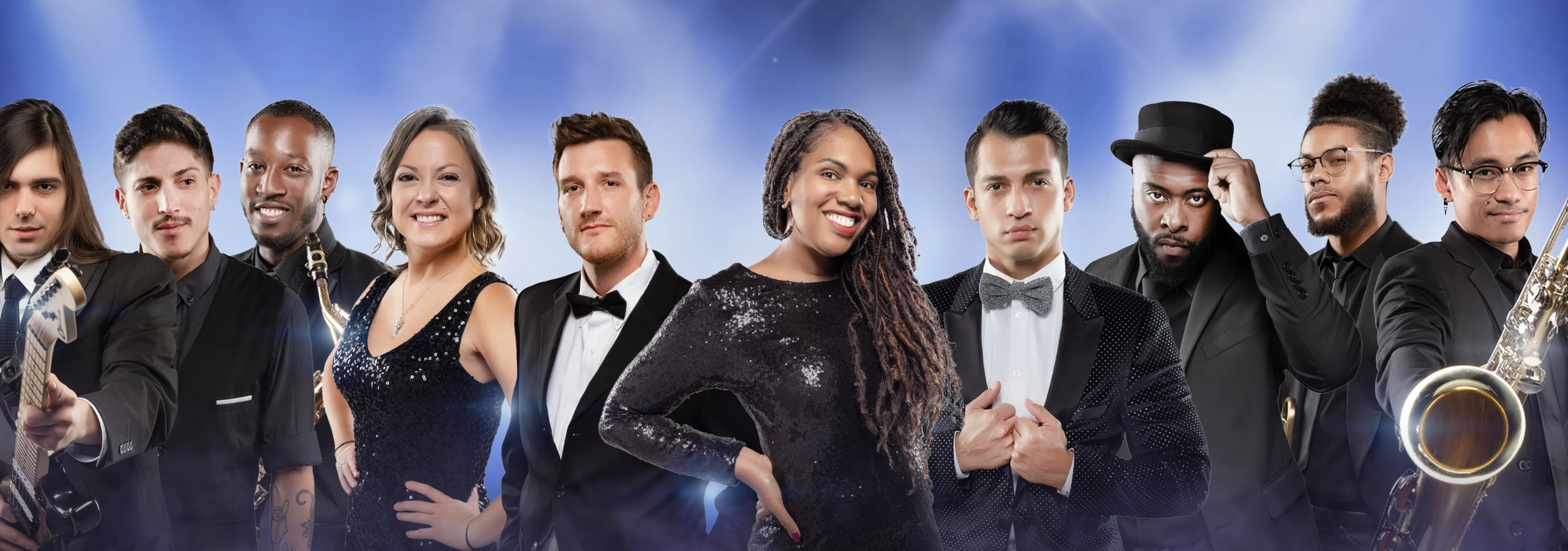 A diverse jazz band dressed in formal attire poses under stage lights.