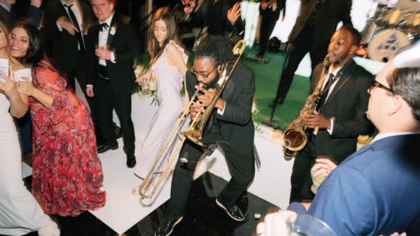 Man playing at trombone at a party
