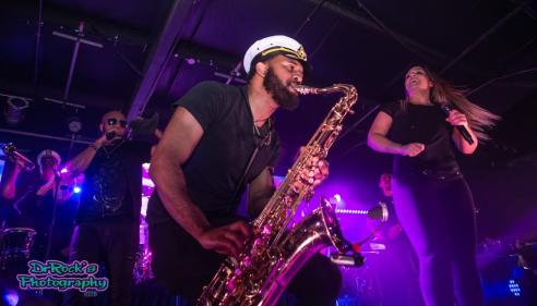 man playing saxophone on stage