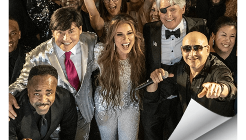 Group of people dressed formally, smiling and celebrating at an event, People logo in corner.