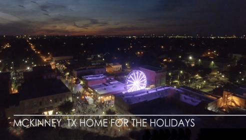 Arial photo of a town at night with a ferris wheel