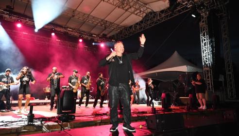 Deno of Emerald City Band on a stage