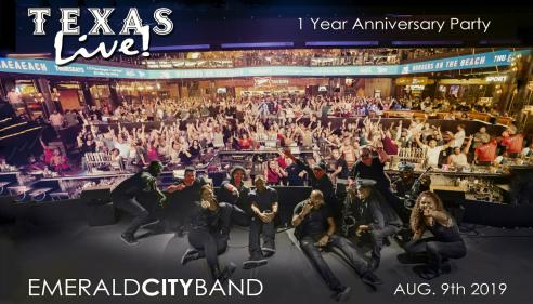 Members of Emerald City Band lay on the stage in front of a large crowd