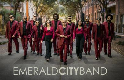 Emerald City Band members in red suits waking down a street