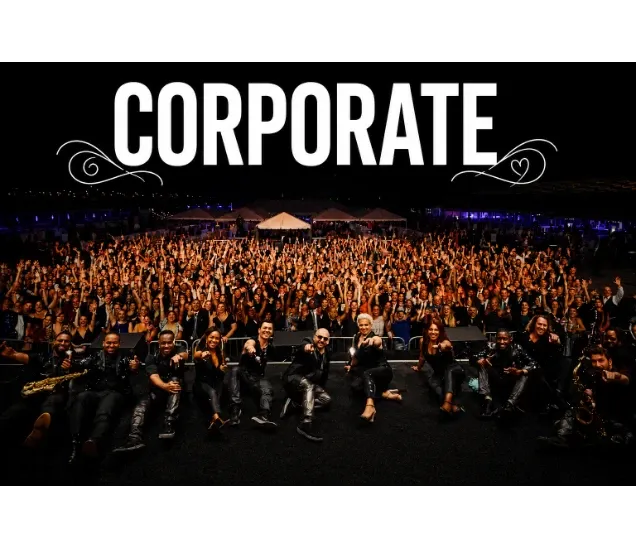 Large group of people posing together outdoors at night, "CORPORATE" text above them.