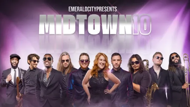 Eleven musicians in black outfits posing together with purple lighting in the background.