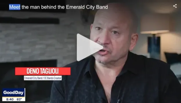 Bald man speaking in an interview, lower third reads "Deno Taglioli, Founder/Producer, Emerald City Band."