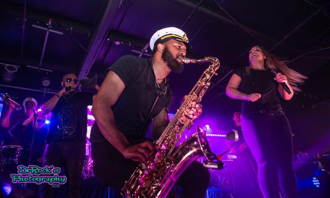 man playing saxophone on stage