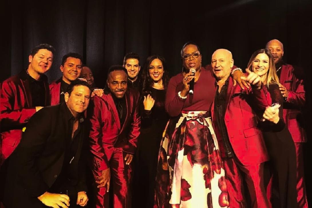 members of Emerald City Band with Oprah Winfrey