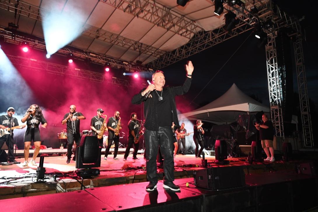 Deno of Emerald City Band on a stage