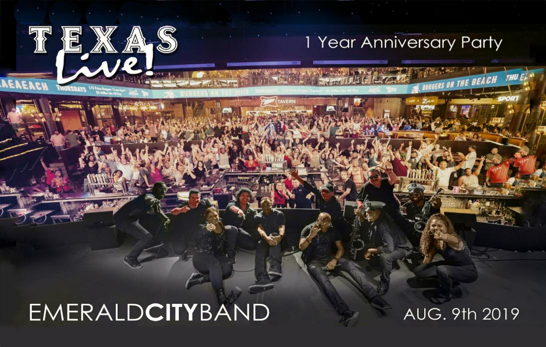 Members of Emerald City Band lay on the stage in front of a large crowd
